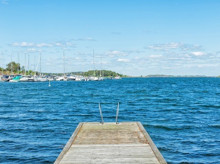 Wooden bridge on the way to the harbor. Freedom conceptの写真素材
