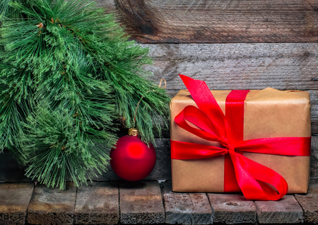 Christmas background with red Christmas ball and gift. Vintage gray wallの写真素材
