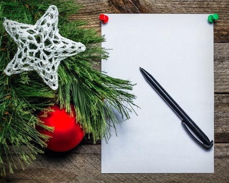 Christmas background with red Christmas ball and paper with pen for your text. Vintage gray wallの写真素材