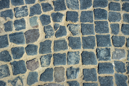 Cobbled pavement made of granite cubes. Background texture.の写真素材