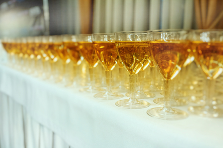 Catering services. glasses with wine in row background at restaurant partyの写真素材