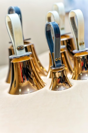 Set of gold handbells on table during concert. Christmas timeの写真素材