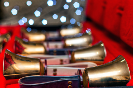 Set of gold handbells in red box with bokeh defocused blurred. Christmas timeの写真素材