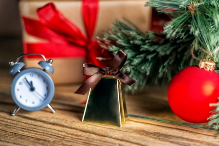 Christmas decoration red ball, baubles, handbells and antique clock on wooden backgroundの写真素材