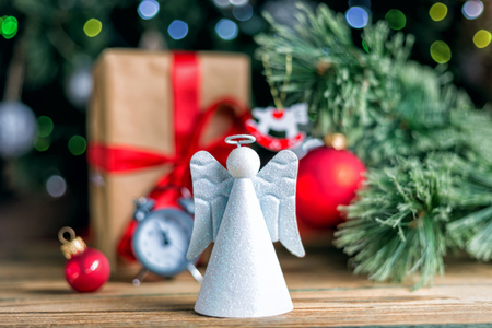 Christmas decoration red ball, baubles, angel and antique clock on wooden backgroundの写真素材
