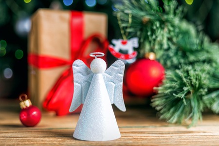 Christmas decoration red ball, baubles, angel and antique clock on wooden backgroundの写真素材