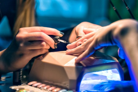 Manicure set in a beauty salon. Beautiful female handsの写真素材