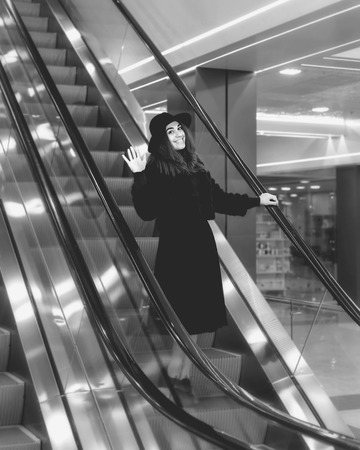 The girl on an escalator in a big storeの写真素材