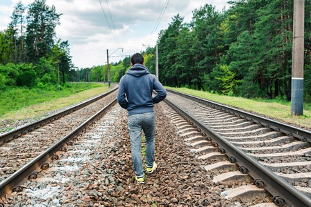 Man in depression going on rail stationの写真素材