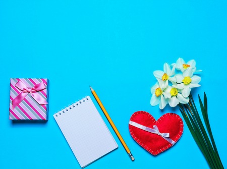Blank page notepad with gift box and hearts on a nice background. Valentine's Day background. Space for text, top view.の写真素材