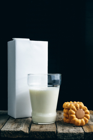 Tasty cookies and glass of milk on rustic wooden backgroundの写真素材