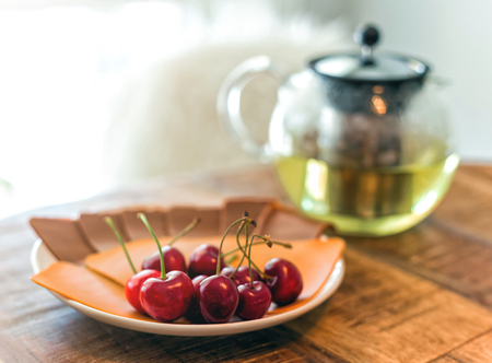 Breakfast with tea, cheese and cherryの写真素材