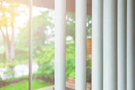 Rising sun behind window blindsの写真素材