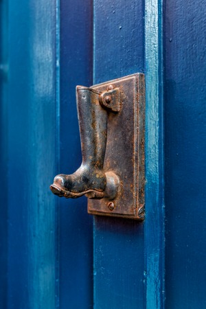 Artistic vintage dark edit of an old iron metal door knockerの写真素材