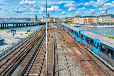 Railway tracks and trains in main train station in Stockholm, Sweden in sunsetの写真素材
