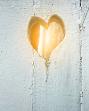 Old white wooden door with heart close upの写真素材