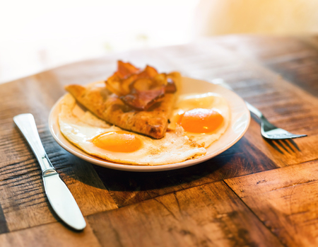 American breakfast with fried egg, becon and breadの写真素材