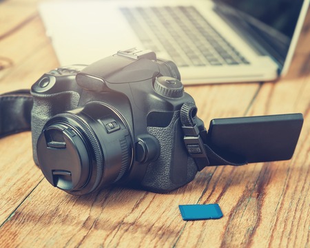 Camera on wood table background. Vintage tone.の写真素材