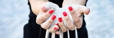 panorama of woman holding sand in her hands panoramaの写真素材