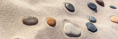 beautiful stones different colors on the sand horizontal, panoramaの写真素材