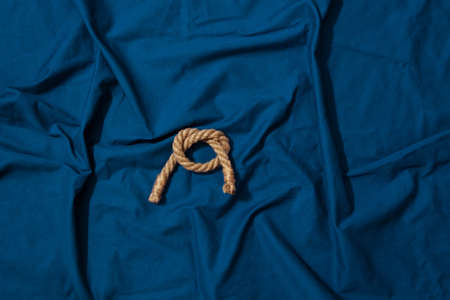 rope bend on blue fabricの写真素材