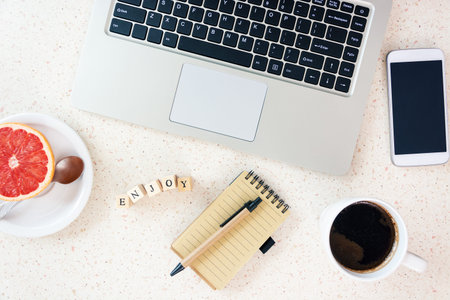 red grapefruit mug of coffee smartphone home office remote working table