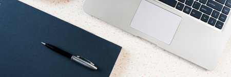 desktop with laptop notebook pen and plate with croissant horizontal, panorama, panoramic