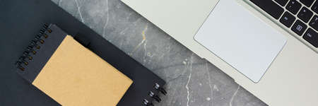 laptop computer keyboard and notebooks on concrete table horizontal, panorama, panoramicの写真素材