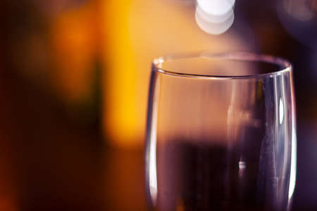 empty shinning glass on blurred backgroundの写真素材