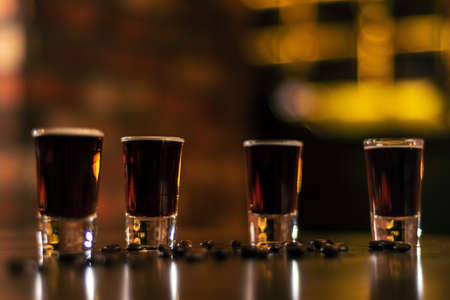 coffee shoots on bar wooden table raw coffee beans on blurred backgroundの写真素材