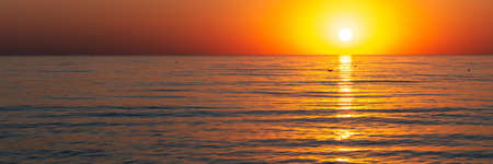 sun goes down by the seaの写真素材