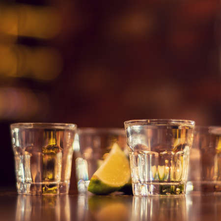 alcohol shots on wooden table squareの写真素材
