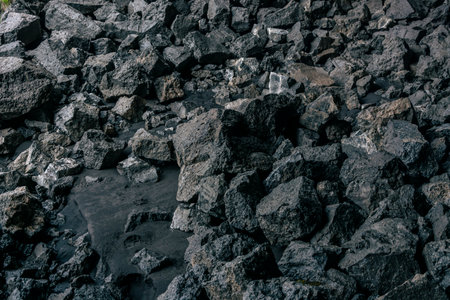 Black volcanic rock texture background. Close up of black volcanic stones.の写真素材
