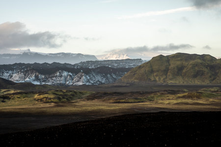 Icelandic landscape with mountains and rocks in the foreground at sunriseの写真素材