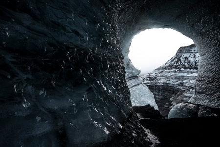 Ice cave in the mountains. Beautiful winter landscape with blue sky.の写真素材