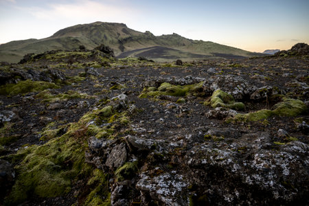 Icelandic landscape with lava fields and volcanic mountains at sunset.の写真素材