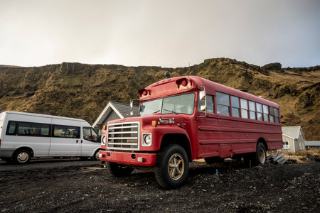 Abandoned red school bus in a volcanic landscape, Iceland.の写真素材