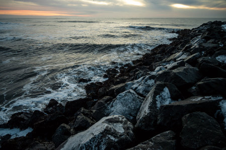 Beautiful seascape with rocks and waves at sunset. Toned.の写真素材