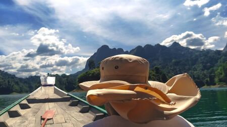 The pleasant sunny day of vacation spent on canoe during the adventurous way through Ratchaprapha Lake in National Park of Khao Sok in Southeast Asia, Thailand.の写真素材