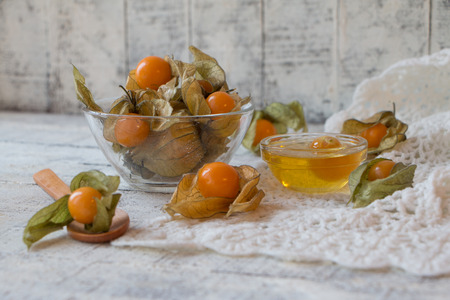 Fresh physalis in a tartlet on a white wooden tableの写真素材