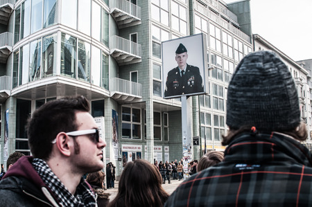 Checkpoint Charlie in Berlin was the crossing point Between East and West Berlin sectors during the Cold War. In the photo, visitors people.のeditorial素材