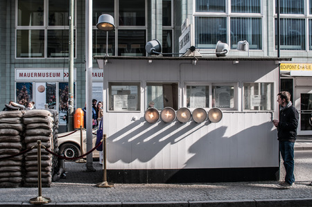 Checkpoint Charlie in Berlin was the crossing point Between East and West Berlin sectors during the Cold War. In the photo, visitors people.のeditorial素材