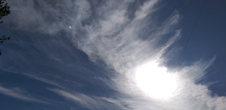 Blue sky with white clouds and sun. The vast blue sky and clouds sky on sunny day. White fluffy clouds in the blue sky.の写真素材