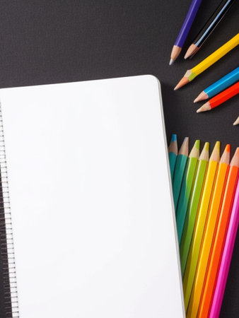 Pencils and notebook on black background. Back to school concept.の素材