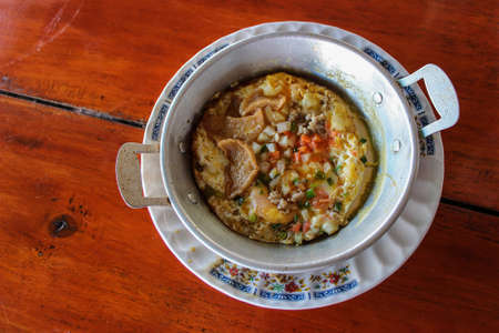Pan fried egg with pork, sausage, and topping in wooden table - Breakfast thai foodの写真素材