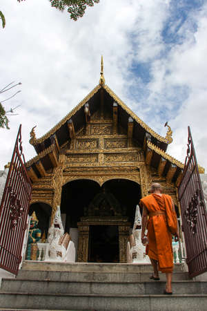 Buddhist monk walking to the temple - sky backgroundの写真素材