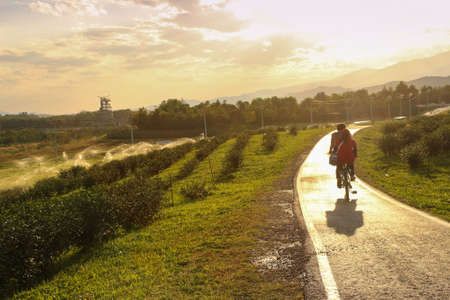Bikers biking in park during sunset - sport activityの写真素材