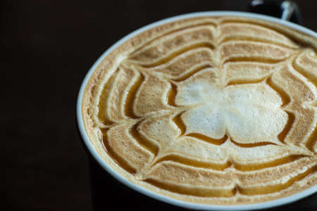 Close up of cappuccino coffee on wooden tableの写真素材