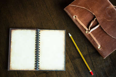 Top view of vintage paper book with space and pencil on wooden background, Book Texturedの写真素材