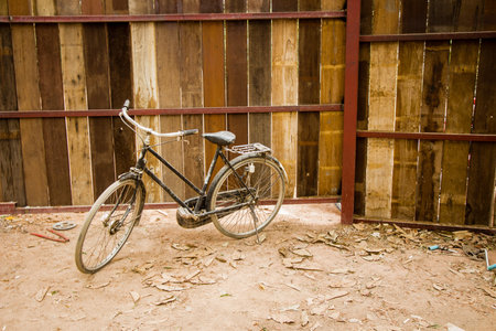 Vintage bicycle on vintage wooden fence wallの写真素材